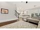 Open-concept living space with hardwood floors leading to a bright kitchen and staircase at 29 Cliftwood Dr, Sandy Springs, GA 30328
