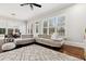 Spacious living room with a large sectional sofa, ample natural light, and hardwood floors with decorative rug at 29 Cliftwood Dr, Sandy Springs, GA 30328