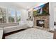 Inviting living room featuring a stone fireplace, built-in shelving, and a comfortable neutral-toned sofa at 29 Cliftwood Dr, Sandy Springs, GA 30328