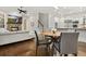 Open floor plan showcases living room with fireplace and waterfall TV, dining area, and modern kitchen at 29 Cliftwood Dr, Sandy Springs, GA 30328