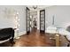 Spacious home office with hardwood floors, stylish decor, and glass doors to the home's interior at 29 Cliftwood Dr, Sandy Springs, GA 30328