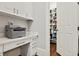 Well-organized pantry with ample shelving and storage space, next to built-in desk and cabinets at 29 Cliftwood Dr, Atlanta, GA 30328