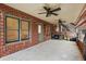 Covered patio with brick walls, ceiling fans, and access to the backyard and stairs at 29 Cliftwood Dr, Sandy Springs, GA 30328