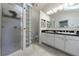 Bathroom showcasing a glass block shower, double sinks, and tiled floor at 3151 Rilman Nw Rd, Atlanta, GA 30327