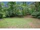 Tranquil backyard featuring mature trees and lush green grass at 1007 E Callaway Sw Rd, Marietta, GA 30060