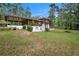 Wide lawn in backyard and partially covered patio of a brown two story home at 1007 E Callaway Sw Rd, Marietta, GA 30060