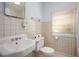 Small bathroom with a white sink, toilet, and tiled walls at 1007 E Callaway Sw Rd, Marietta, GA 30060