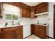 Functional kitchen featuring wood cabinets and a white dishwasher at 1007 E Callaway Sw Rd, Marietta, GA 30060