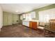 Spacious kitchen with worn cabinets and two rocking chairs at 1007 E Callaway Sw Rd, Marietta, GA 30060