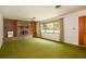 Spacious living room featuring a brick fireplace and large window at 1007 E Callaway Sw Rd, Marietta, GA 30060