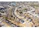 Aerial view of a neighborhood with winding streets, manicured lawns, and a lake in the background at 1331 Dayspring Trce, Lawrenceville, GA 30045