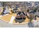 Aerial view of large brick home with well-manicured lawn and mature trees at 1331 Dayspring Trce, Lawrenceville, GA 30045