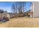 Backyard view showing trees, deck, patio, and house's siding at 1331 Dayspring Trce, Lawrenceville, GA 30045