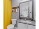 Well-lit bathroom showcasing neutral walls, a large mirror, and a sleek white toilet at 1331 Dayspring Trce, Lawrenceville, GA 30045