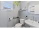 Well-lit powder room with modern fixtures, decorative mirror, and a toilet with sleek black fixtures at 1331 Dayspring Trce, Lawrenceville, GA 30045