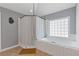 Bathroom featuring tub, shower and large window letting in natural light at 1331 Dayspring Trce, Lawrenceville, GA 30045