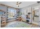 Bright bedroom featuring natural light, neutral walls, and play area with a decorative rug at 1331 Dayspring Trce, Lawrenceville, GA 30045