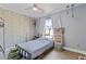 Cozy bedroom with a ceiling fan, light gray flooring, and a natural light filled window at 1331 Dayspring Trce, Lawrenceville, GA 30045