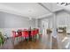 Elegant dining room featuring modern lighting, wainscoting, and a sleek table with red chairs at 1331 Dayspring Trce, Lawrenceville, GA 30045