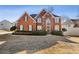 Charming two-story brick home with a manicured lawn and lush landscaping at 1331 Dayspring Trce, Lawrenceville, GA 30045