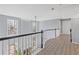 Upstairs hallway featuring wood floors, a white banister, and plenty of natural light at 1331 Dayspring Trce, Lawrenceville, GA 30045