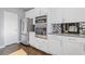 Modern kitchen with stainless steel appliances, white cabinetry and gray countertop at 1331 Dayspring Trce, Lawrenceville, GA 30045