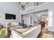 Sunlit living room featuring a fireplace, high ceilings, and an open floor plan at 1331 Dayspring Trce, Lawrenceville, GA 30045