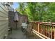 Outdoor deck area with green chairs, table, string lights, and partial brick wall at 1552 Mosaic Way, Smyrna, GA 30080