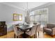 Sophisticated dining area with chandelier, large window and polished hardwood floors at 1552 Mosaic Way, Smyrna, GA 30080