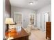 Bright office with wood desk, white chair, printer and natural light from the door and window at 1552 Mosaic Way, Smyrna, GA 30080