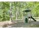 Community playground area with a play structure, slide, and swings surrounded by trees at 1552 Mosaic Way, Smyrna, GA 30080