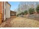 View of the backyard of this lovely home with screened porch and retaining wall at 1085 Highland Crest Ct, Mableton, GA 30126