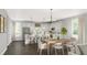 Spacious open concept with a modern white kitchen island and pendant lights blending into the dining area at 2709 Creek View Nw Ter, Atlanta, GA 30318