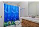 This bathroom features a toilet, a sink, and a shower with a dolphin-themed curtain at 6153 Idlewood Pass, Lithonia, GA 30038