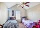 This bedroom features two twin beds, a ceiling fan, a window with blinds, and carpet at 6153 Idlewood Pass, Lithonia, GA 30038