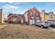 Charming two-story home with brick facade and a two-car garage with basketball hoops at 6153 Idlewood Pass, Lithonia, GA 30038