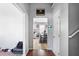 Inviting hallway with hardwood floors leading to a dining area and tiled kitchen at 6153 Idlewood Pass, Lithonia, GA 30038