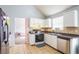 Efficient kitchen with stainless steel appliances, white cabinets, and tiled flooring at 6153 Idlewood Pass, Lithonia, GA 30038