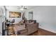 Cozy living room with hardwood floors, a comfortable sofa, and a ceiling fan at 6153 Idlewood Pass, Lithonia, GA 30038