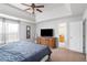 Serene main bedroom featuring a tray ceiling, neutral colors, and an ensuite bathroom at 6153 Idlewood Pass, Lithonia, GA 30038