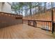 View of the back deck with a wooden fence, string lights and wooded backyard at 1152 Liberty Nw Pkwy, Atlanta, GA 30318