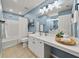 Bathroom with shower, bath, and white vanity. Decorative shelves add storage in the space at 1152 Liberty Nw Pkwy, Atlanta, GA 30318