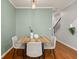 A dining area featuring a hardwood floor, a modern light fixture, and a wooden dining table with four chairs at 1152 Liberty Nw Pkwy, Atlanta, GA 30318