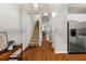 Hallway features hardwood floors, staircase leading to the second floor, and stainless steel refrigerator at 1152 Liberty Nw Pkwy, Atlanta, GA 30318