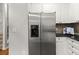 Modern stainless steel refrigerator complements the kitchen's design with white cabinetry at 1152 Liberty Nw Pkwy, Atlanta, GA 30318