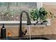 Close up of kitchen sink with sleek black faucet, stone backsplash, and ample countertop space at 1152 Liberty Nw Pkwy, Atlanta, GA 30318