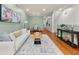 Spacious living room showcases hardwood floors, a modern light fixture, and a white couch with a coffee table at 1152 Liberty Nw Pkwy, Atlanta, GA 30318