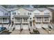 A row of inviting townhomes with garages and balconies, showcasing a tidy facade and modern architectural details at 1152 Liberty Nw Pkwy, Atlanta, GA 30318