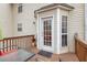 View of the back porch showing the exterior door and a table with chairs at 144 Fox Creek Dr, Woodstock, GA 30188