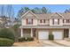 Inviting townhome with a brick facade, red shutters, and a well-maintained front yard at 144 Fox Creek Dr, Woodstock, GA 30188